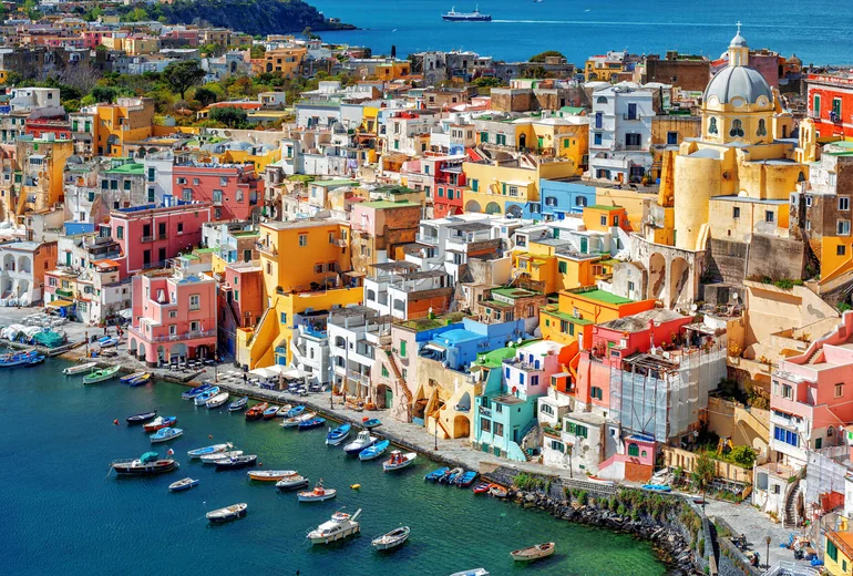 Procida island with pastel houses and fishing boats
