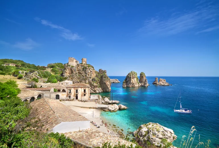 Sicilian-style cliffside village with sandy beach