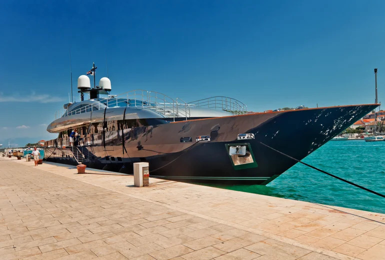 Yacht stern-to in a Mediterranean marina at sunset