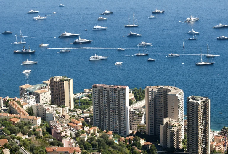 Mediterranean fishing village with anchored yachts
