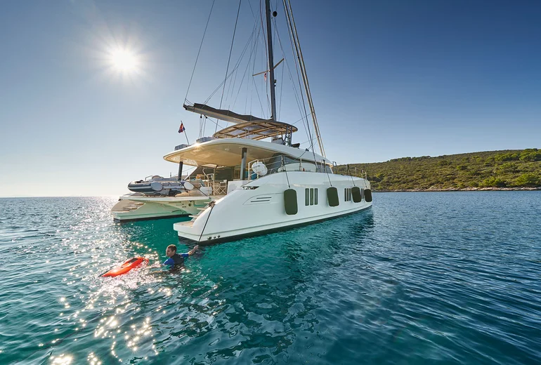 Catamaran sundeck looking out over a Greek anchorage