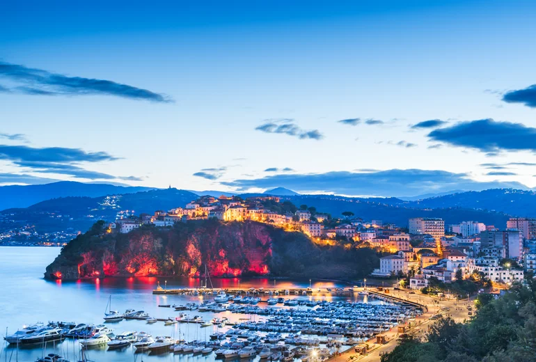 Agropoli waterfront with fishing boats and houses on the cliff