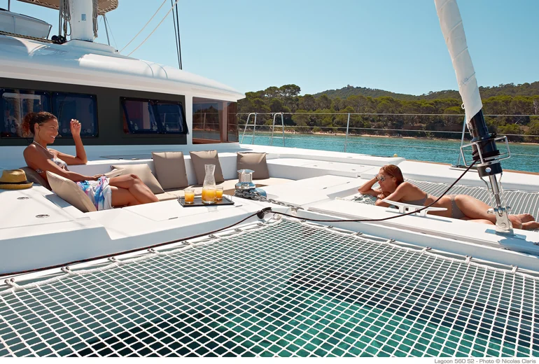 Catamaran cruising along an Adriatic shoreline