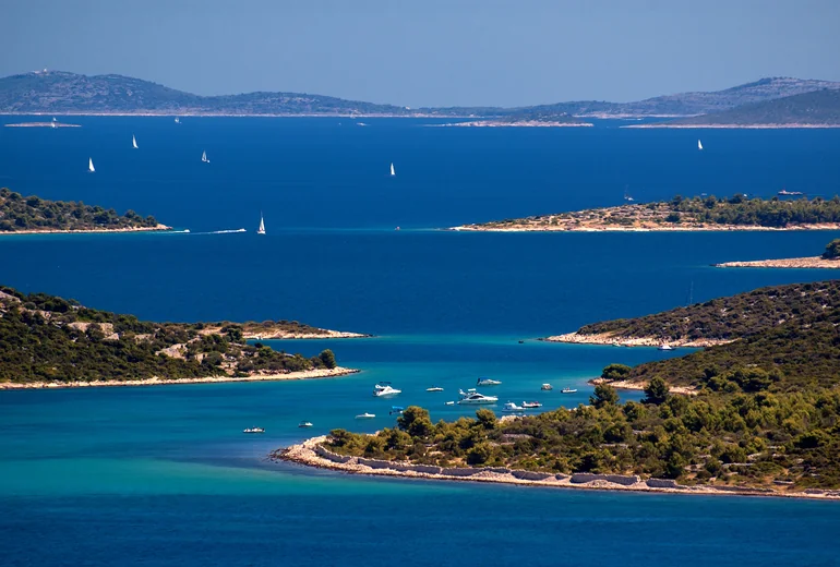 Croatian island bay with anchored sailing yachts