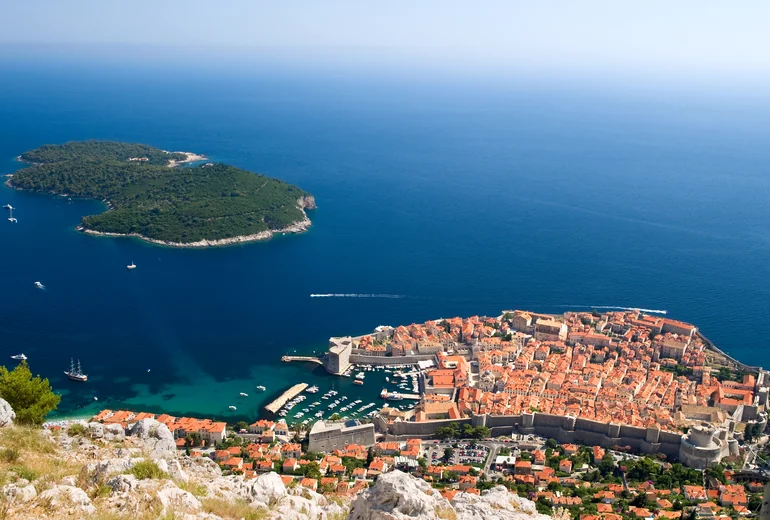 Hvar town from the sea with stone buildings on the hillside